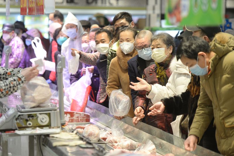 Customers wearing face masks shop inside a supermarket following an outbreak of the novel coronavirus in Wuhan