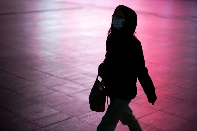 A woman wears a protective mask at the Shanghai railway station in Shanghai