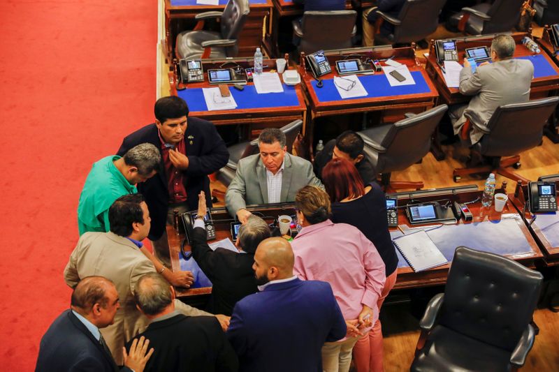 Representatives discuss during congress session on the approval of an amnesty bill that exempts the prosecution of crimes committed during the civil war, in San Salvador, El Salvador