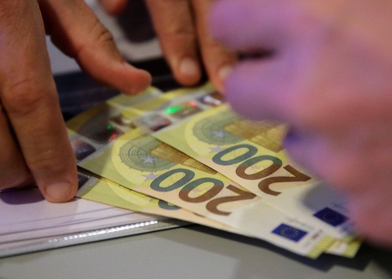 An Austrian central bank official takes new 200 euro banknotes in Vienna