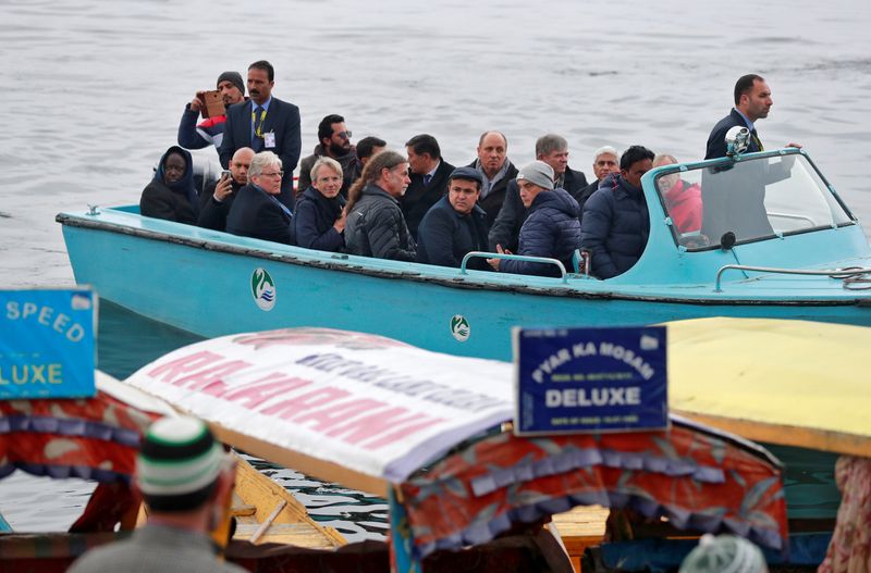 Foreign diplomats are seen in a motorboat in Dal Lake in Srinagar