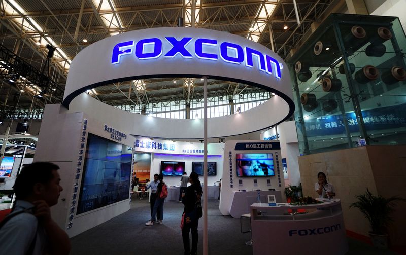 FILE PHOTO: Visitors are seen at a Foxconn booth at the World Intelligence Congress in Tianjin