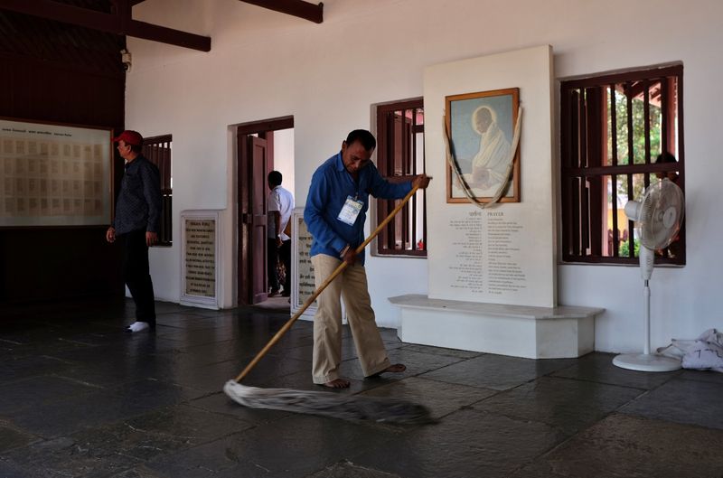 A worker mops the floor inside Gandhi Ashram, where U.S. President Donald Trump is expected to visit, in Ahmedabad