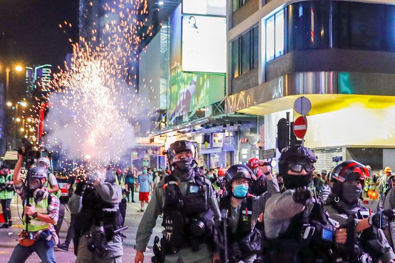 Riot police shoots a tear gas to disperse anti-government protesters after a clash at Mong Kok, in Hong Kong