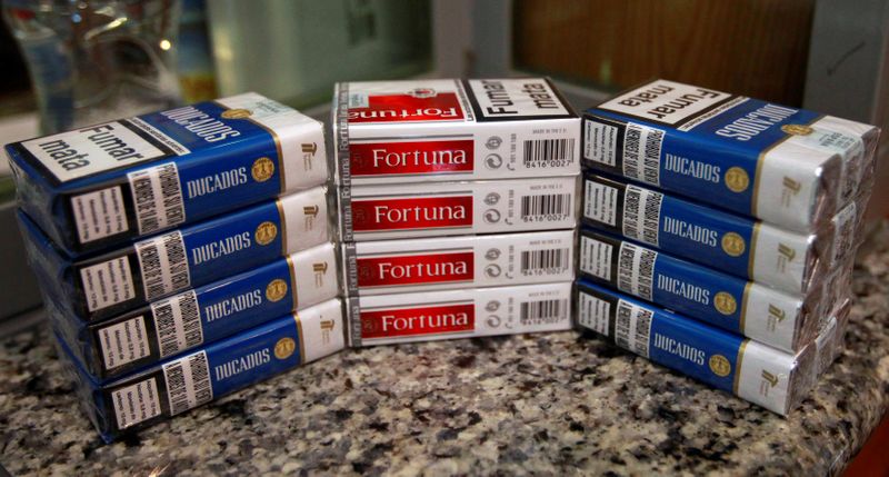 FILE PHOTO: Cigarette packs of Imperial Brands, are pictured at a tobacco store in Madrid, Spain