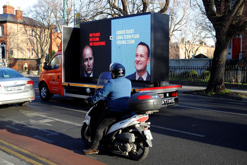 A lorry showing images of Fina Gael leader and current Irish Taoiseach (Prime Minister) Leo Varadkar (R) and Micheal Martin of the Fianna Fail party is seen during the build-up to Ireland's national election in Dublin, Ireland