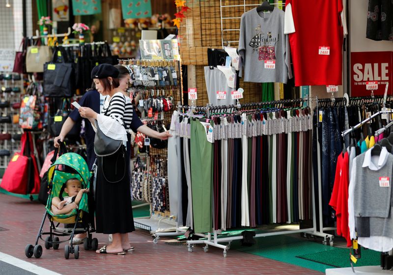 Shoppers look around goods at a shop in Tokyo