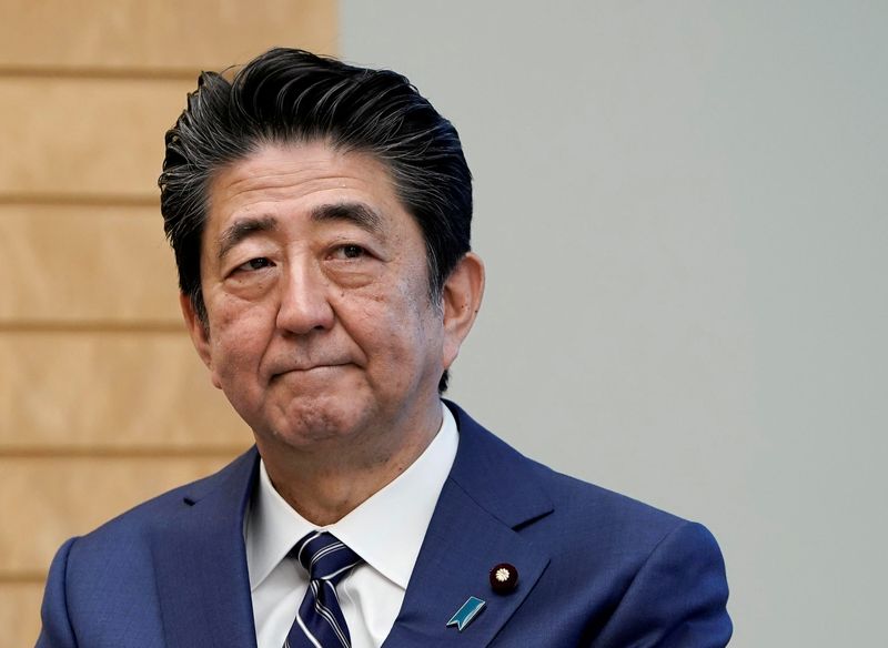 Japanese Prime Minister Shinzo Abe listens to IAEA Director General Rafael Grossi at the prime minister's official residence in Tokyo