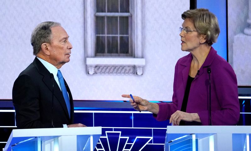 FILE PHOTO: Former New York City Mayor Bloomberg talks with Senator Warren at the ninth Democratic 2020 U.S. Presidential candidates debate in Las Vegas Nevada, U.S.