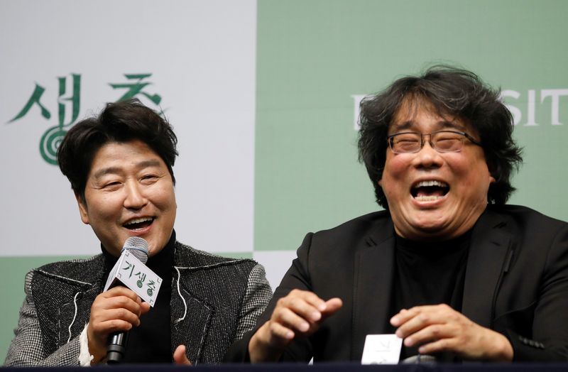 Actor Song Kang-ho of four Oscar award-winning film 'Parasite' answers a reporters' question as Director Bong Joon-ho reacts during a news conference in Seoul