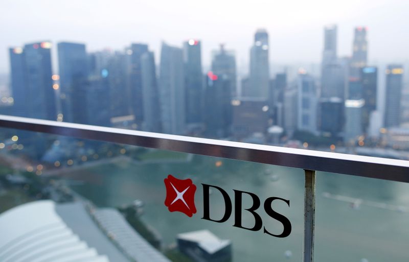FILE PHOTO: A DBS logo in pictured in the backdrop of the central business district in Singapore