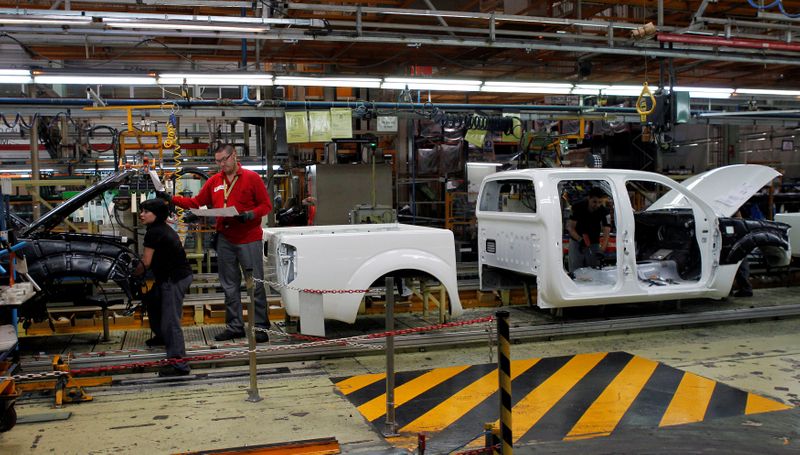 FILE PHOTO: Nissan Motor staff work in a manufacturing chain at the Zona Franca Nissan factory near Barcelona