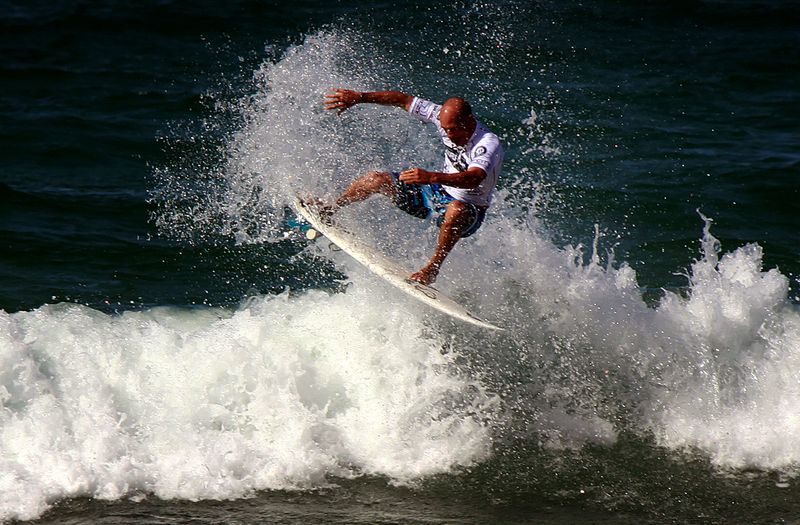 FILE PHOTO: Eleven-time world surfing champion Slater of the US rides a wave during a promotional event at Sydney's Manly Beach