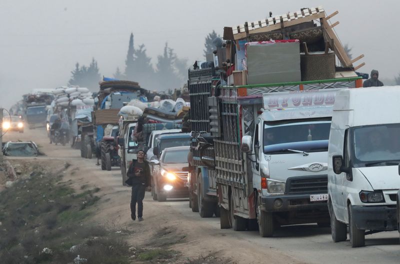 FILE PHOTO: A view of trucks carrying belongings of displaced Syrians, is pictured in the town of Sarmada in Idlib province