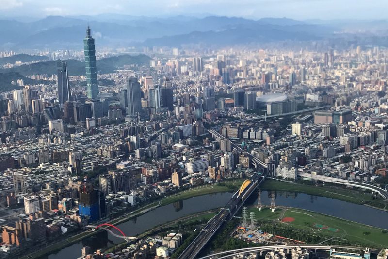 FILE PHOTO: Nan Shan Plaza and Taiwan's landmark building Taipei 101 are pictured through the window of an airplane, in Taipei
