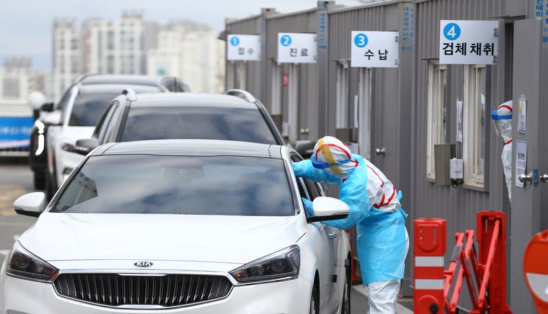 A driver gets a coronavirus test at a drive-through clinic at a hospital in Daegu