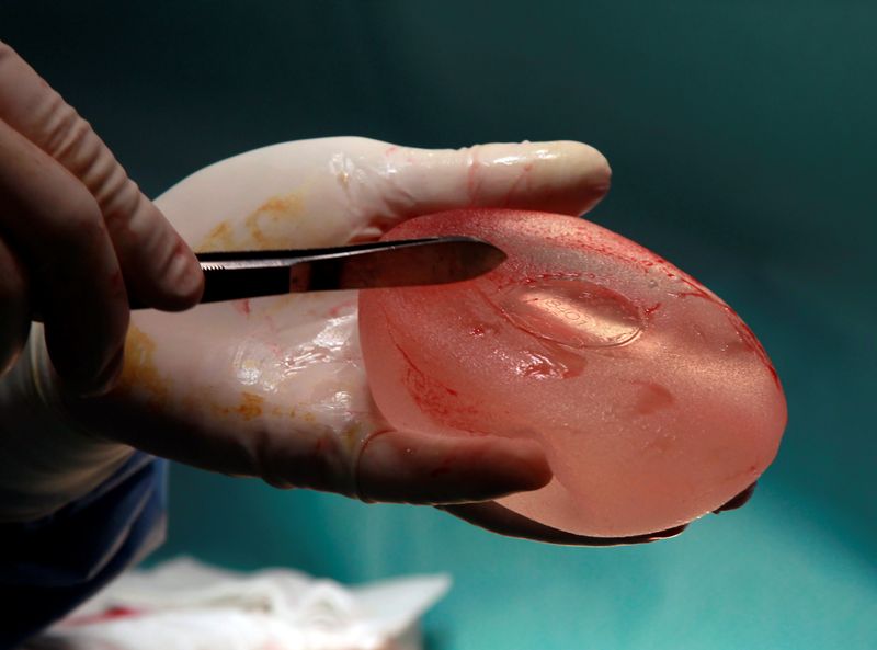 FILE PHOTO: Plastic surgeon Denis Boucq displays at a defective silicone gel breast implant manufactured by French company Poly Implant Prothese after he removed it from a patient in a clinic in Nice