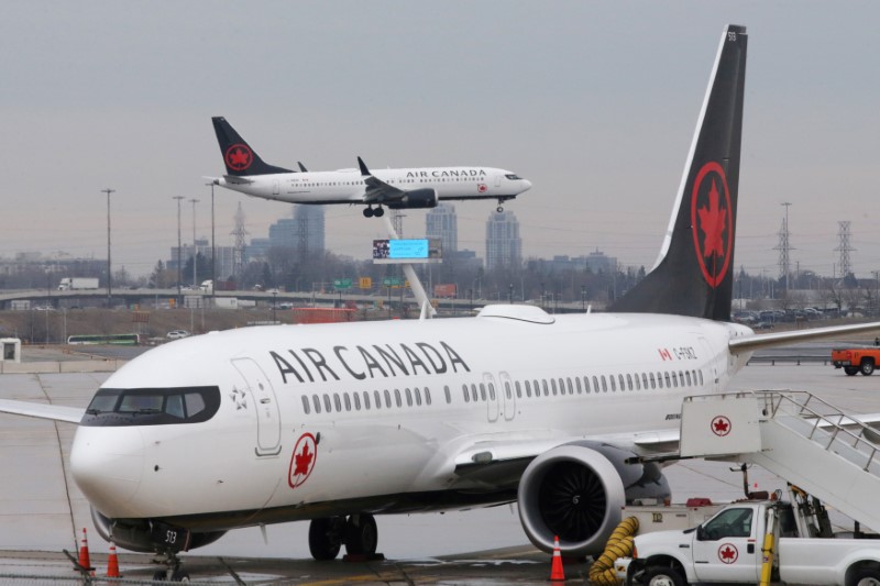 An Air Canada Boeing 737 MAX 8 from San Francisco approaches for landing at Toronto Pearson International Airport over a parked Air Canada Boeing 737 MAX 8 aircraft in Toronto