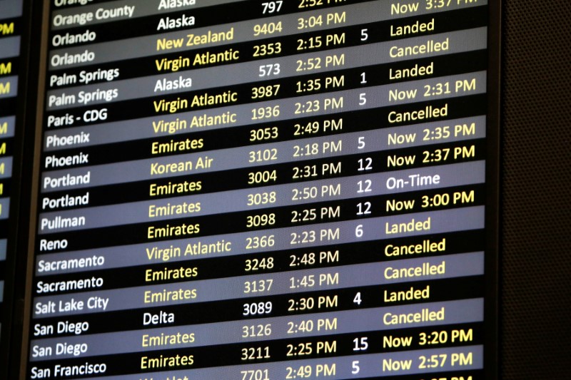 FILE PHOTO: Several canceled flights are pictured on a monitor at Seattle-Tacoma International Airport as airlines are reeling from a plunge in bookings and traffic due to the coronavirus pandemic, in SeaTac, Washington