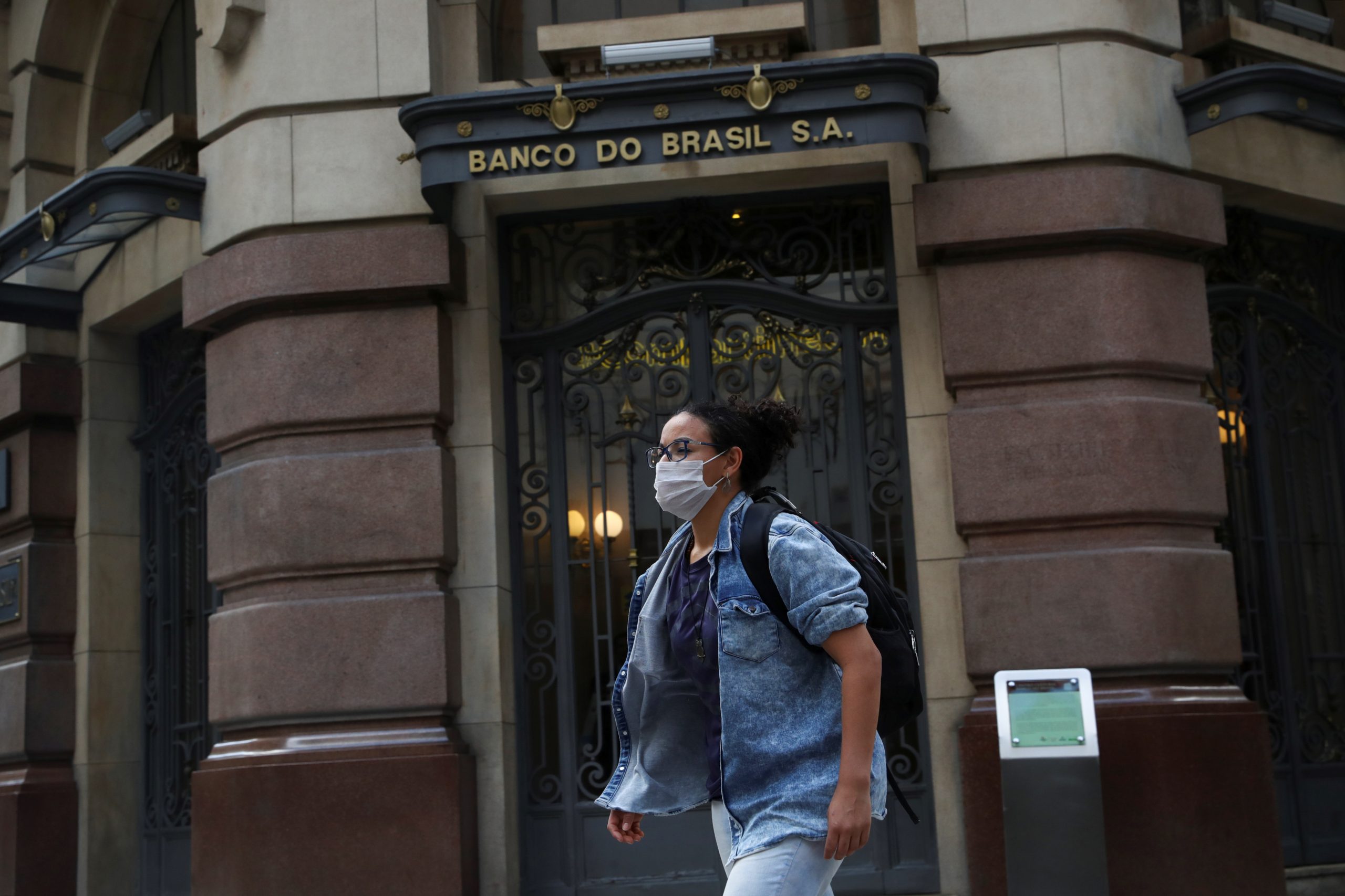 A woman wearing a protective face mask walks in front of Banco do Brasil (Bank of Brazil) cultural building during the coronavirus disease (COVID-19) outbreak in Sao Paulo