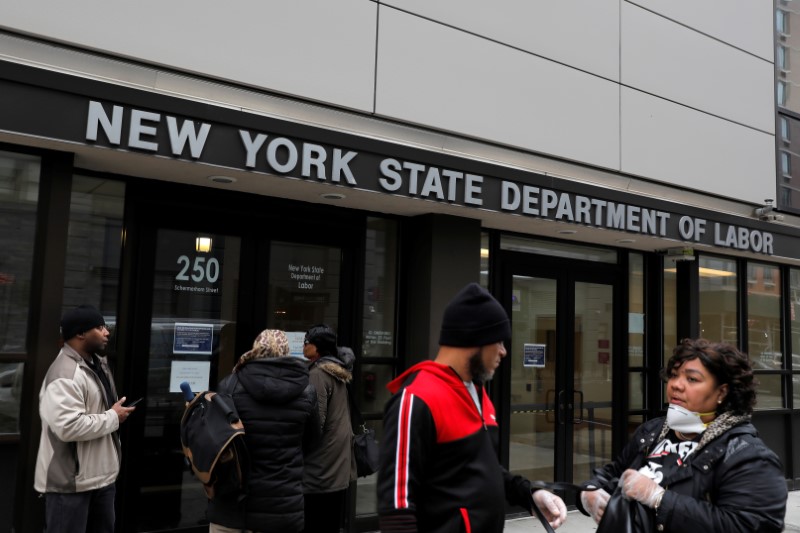 People gather at the entrance for the New York State Department of Labor offices, who closed to the public due to the coronavirus disease (COVID-19) outbreak in the Brooklyn borough of New York City