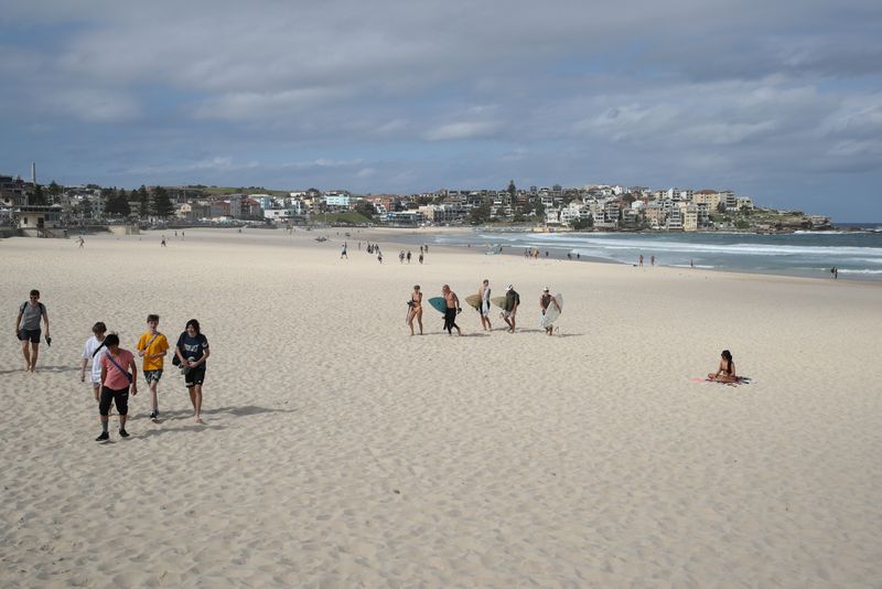 Beachgoers depart Bondi Beach following its closure to prevent the spread of the coronavirus disease (COVID-19) in Sydney