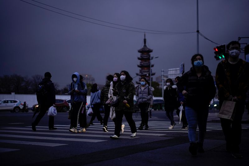 People wearing protective face masks are seen on a crossroads as the country is hit by an outbreak of the novel coronavirus, in Shanghai