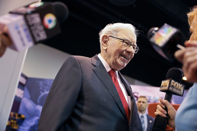 FILE PHOTO: Berkshire Hathaway Chairman Warren Buffett walks through the exhibit hall as shareholders gather to hear from the billionaire investor at Berkshire Hathaway Inc's annual shareholder meeting in Omaha