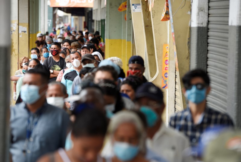 Elderly stand in line to collect their monthly pension before the 4:00 pm - 8:00 am curfew imposed by the government to prevent the spread of the coronavirus disease (COVID-19), in Guayaquil