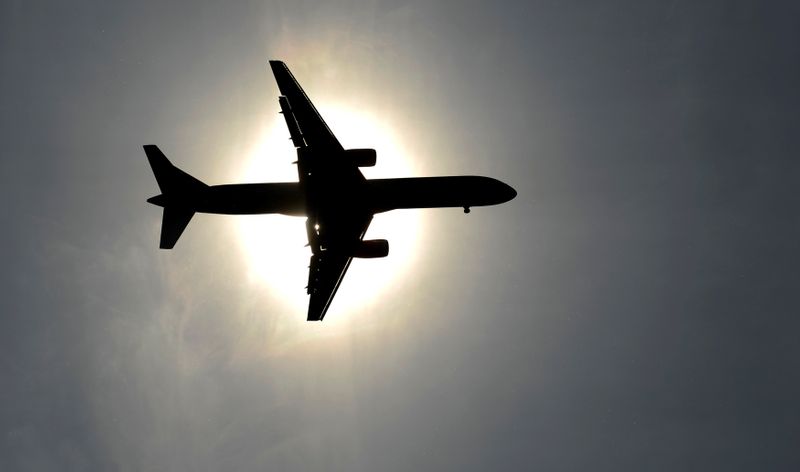 FILE PHOTO: Plane approaching Leeds Bradford airport passes in front of the sun during the second test cricket match between England and New Zealand in Leeds