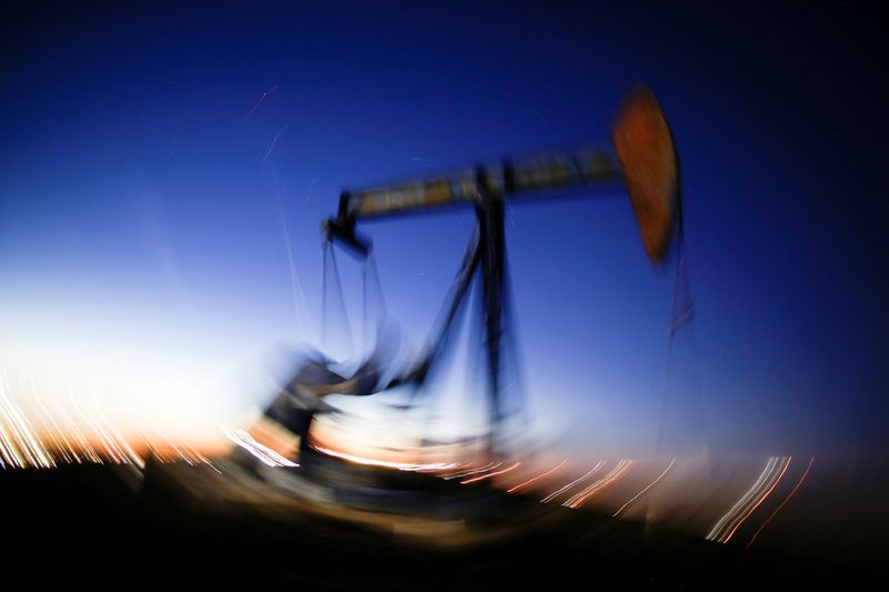 A long exposure image shows the movement of a crude oil pump jack in the Permian Basin in Loving County