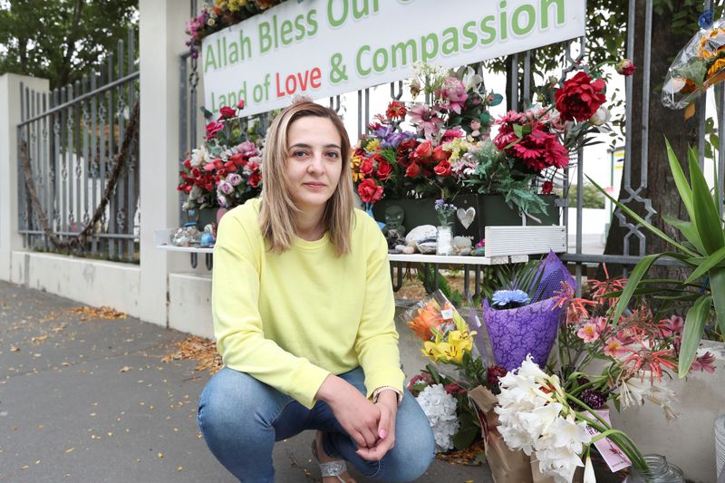 Aya Al-Umari, sister of mosque attack victim Hussein Al-Umari, poses outside Al Noor Mosque in advance of the anniversary of the mosque attacks that took place the prior year in Christchurch