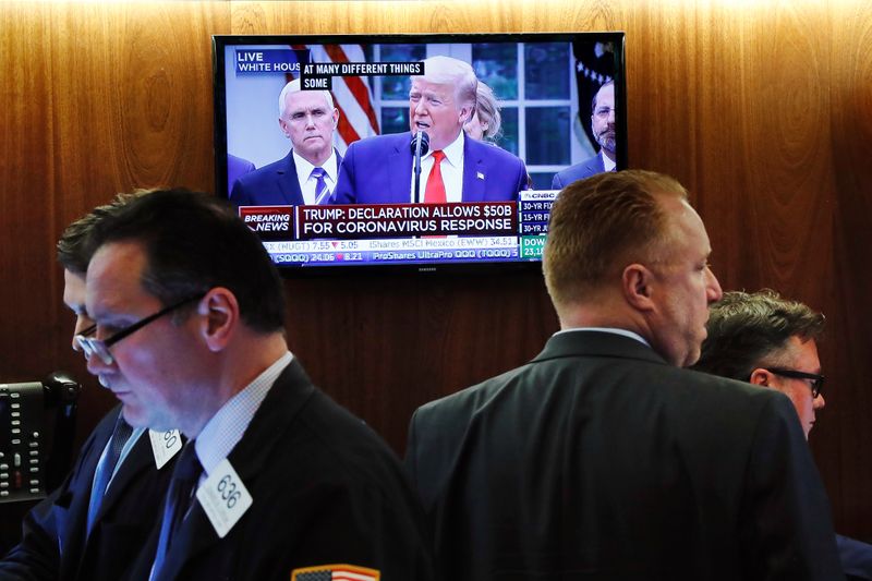 Traders stop to listen to U.S. President Donald Trump speak on the floor of the New York Stock Exchange in New York