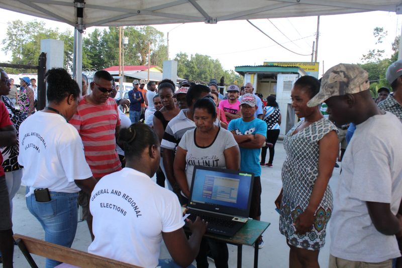 People queue to vote in Guyana's presidential elections in Georgetown