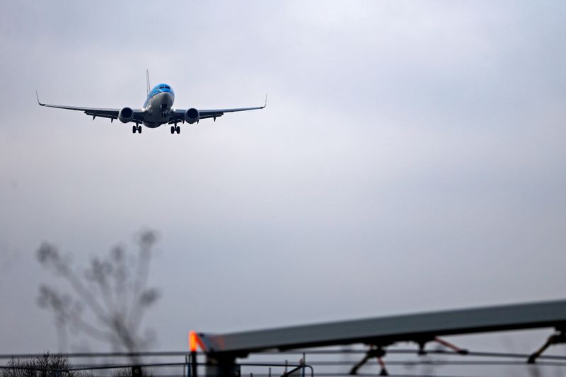 An airplane prepares to land at Cointrin airport in Geneva