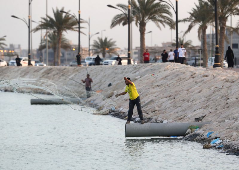 People fish after Saudi Arabia imposed a temporary lockdown on the province of Qatif, following the spread of coronavirus, in Qatif