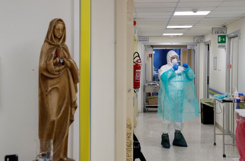 A medical worker in a protective suit is seen at the San Filippo Neri hospital in Rome