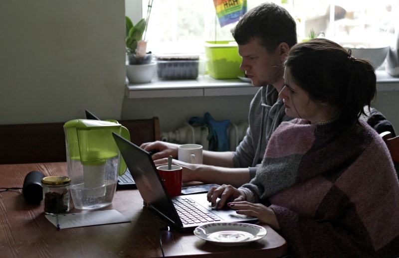 Two people work from home during the outbreak of coronavirus disease (COVID-19), in Gdynia