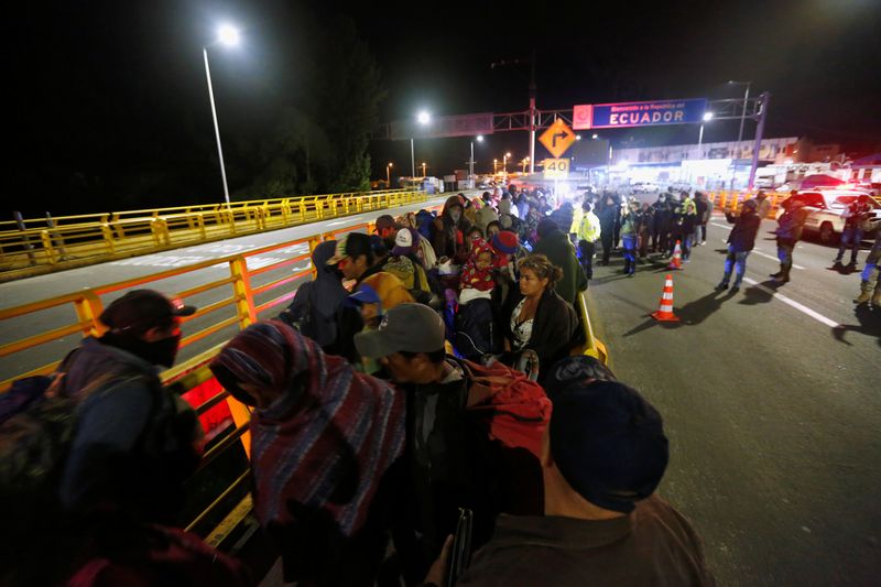 Stranded migrants are pictured at Rumichaca International Bridge between Colombia and Ecuador, after Ecuador's government closed its borders to all foreign travelers due to the spread of the coronavirus disease (COVID-19), in Tulcan