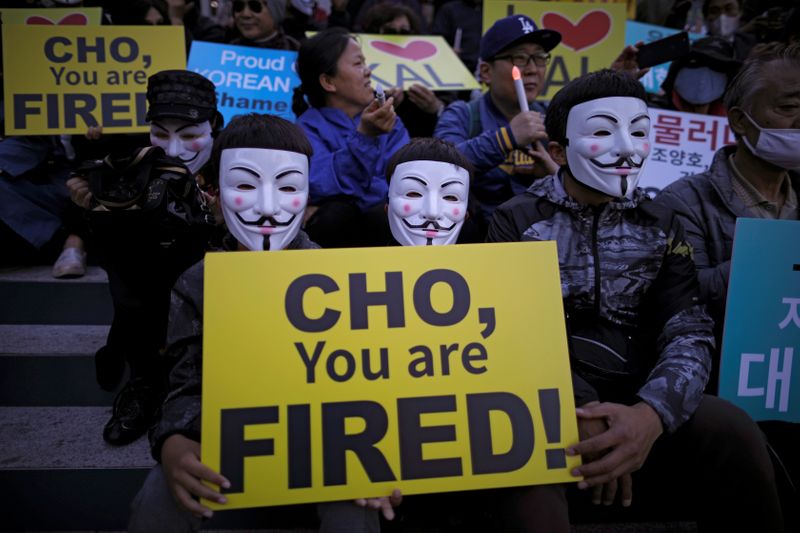 FILE PHOTO: People take part in a protest against the abuse of power by Korean Air Lines' chairman relatives, in central Seoul