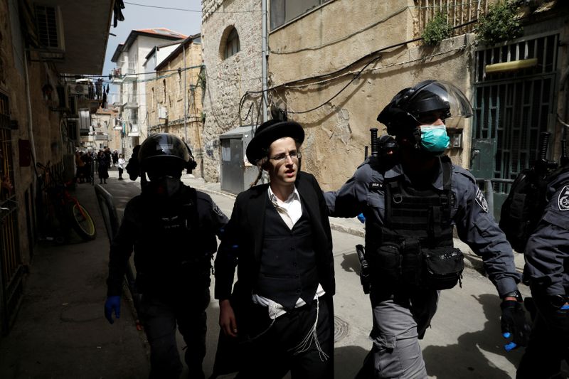 Israeli police detain an ultra-Orthodox Jewish man during scuffles as police enforce a partial lockdown against the coronavirus disease (COVID-19) in Mea Shearim neighbourhood of Jerusalem