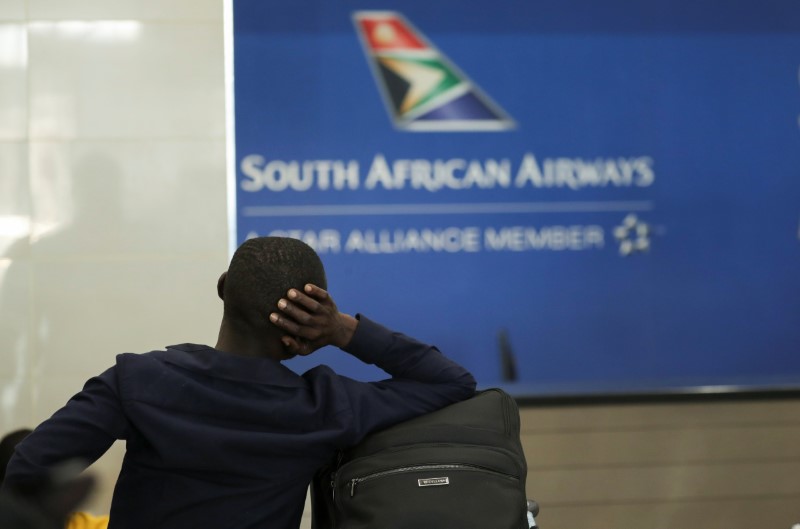 A passenger is seen at the South African Airways (SAA) customer desk at the O.R. Tambo International Airport in Johannesburg