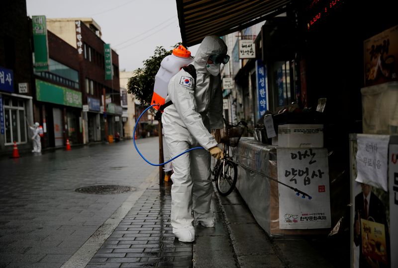 South Korean solider sprays disinfectant at the herbal medicine market street amid the rise in confirmed cases of COVID-19 in Daegu