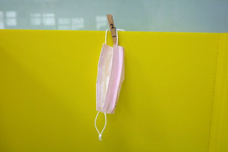 A face mask is hanged on a desk divider at Dajia Elementary school in Taipei