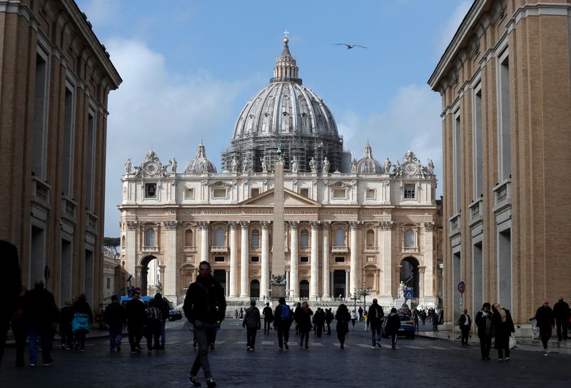 People walk on St. Peter's Square after the Vatican reports its first case of coronavirus