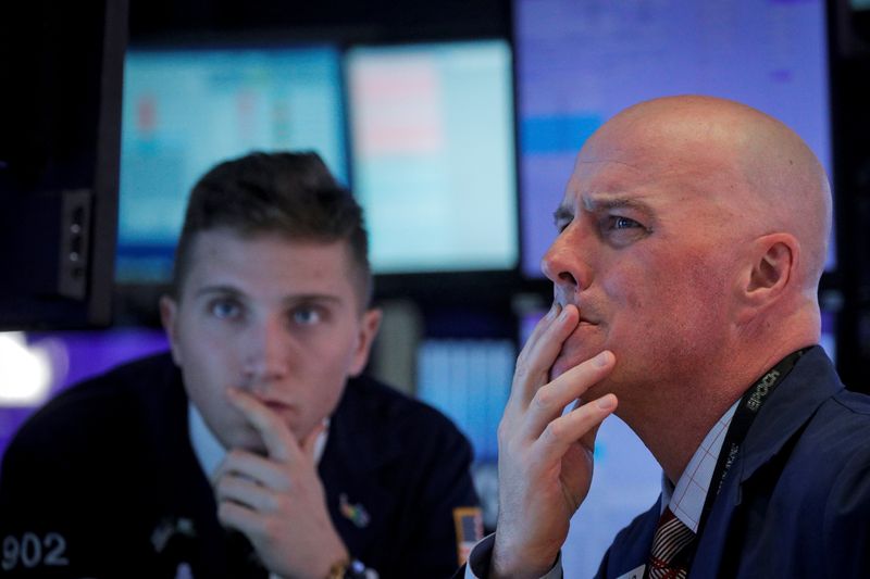 Traders work on the floor at the NYSE in New York