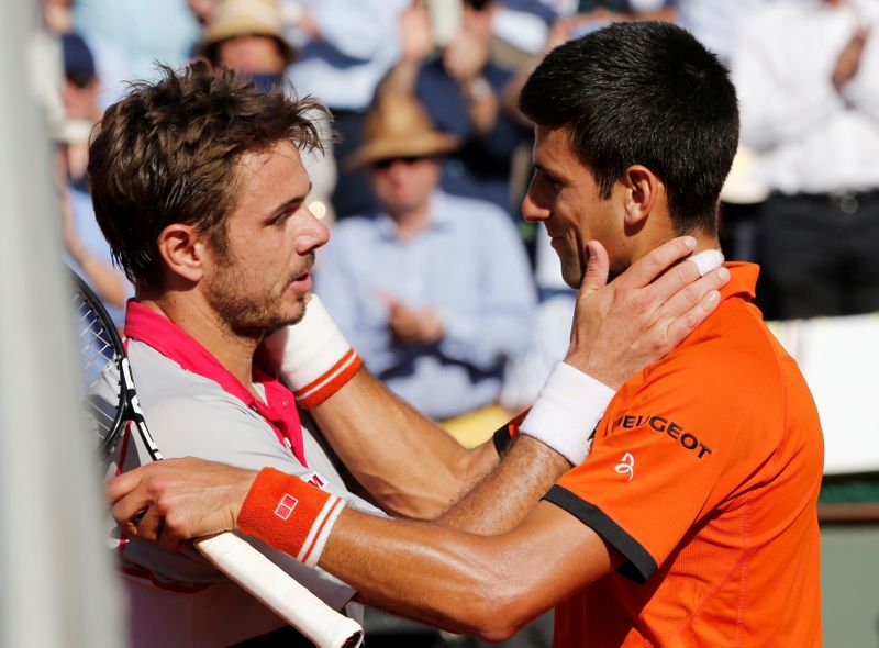 FILE PHOTO: Stan Wawrinka of Switzerland (L) hugs Novak Djokovic of Serbia after winning the 2015 French Open men's final