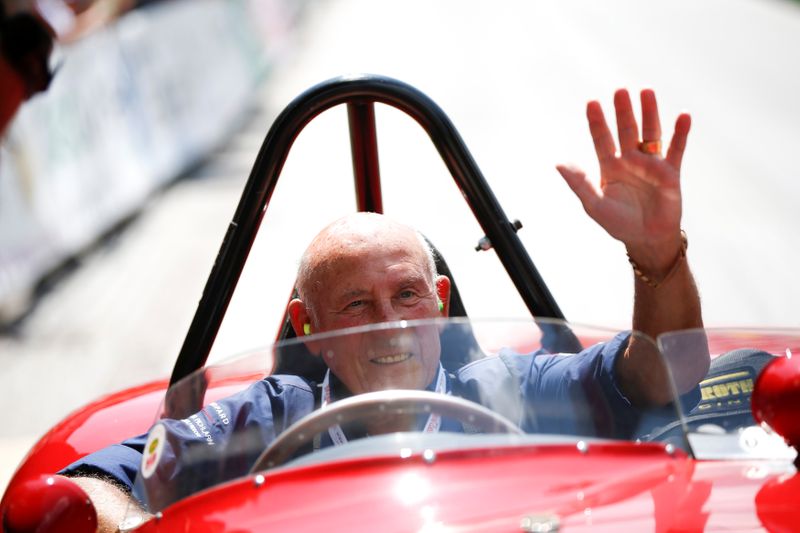 FILE PHOTO: Former English Formula One driver Stirling Moss waves to spectators as he sits in his 1955 Ferrari 750 Monza during the Ennstal Classic rally near Groebming