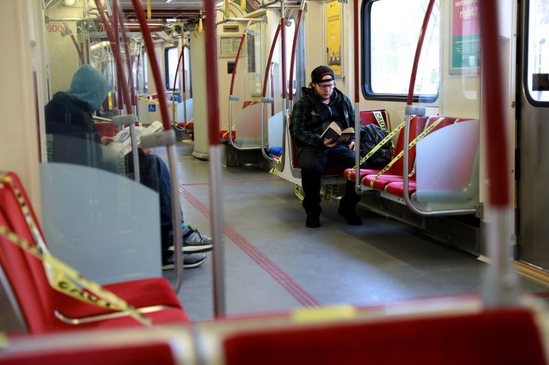 Passengers ride the subway with seats marked for social distancing during the coronavirus disease restrictions in Toronto