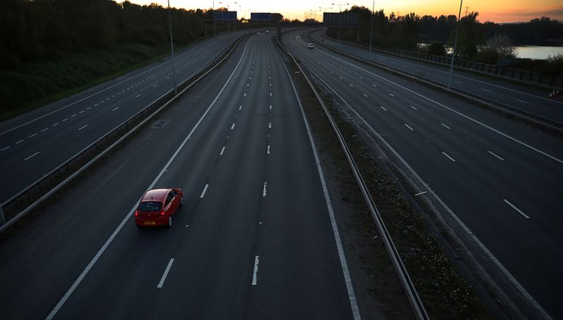 A car travels along a deserted stretch of the M60 motorway, as the spread of the coronavirus disease (COVID-19) continues, Manchester, Britain